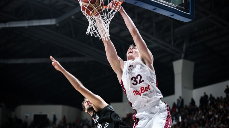 Anžejs Pasečņiks triec bumbu pāri Doušam Ezdemirolu. Foto: FIBA